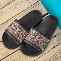 Pair of native-style slide sandals on wood: black footbed, multicolor strap