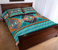 Multicolor quilt bed set with teal center panel, geometric triangles and two pillowcases