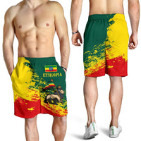 Ethiopia flag graphic swim shorts, green yellow red splatter pattern, elastic waistband
