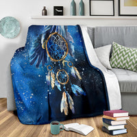 Blue galaxy dreamcatcher blanket draped over couch, speckled night-sky pattern and rings