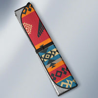 Folded auto sun shade with red, orange, blue geometric tribal pattern and black trim