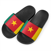 Cameroon slide sandals pair: black straps with red/yellow flag panel and gold star