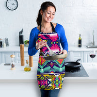 Multicolor geometric apron worn over a blue shirt; black neck strap and waist ties