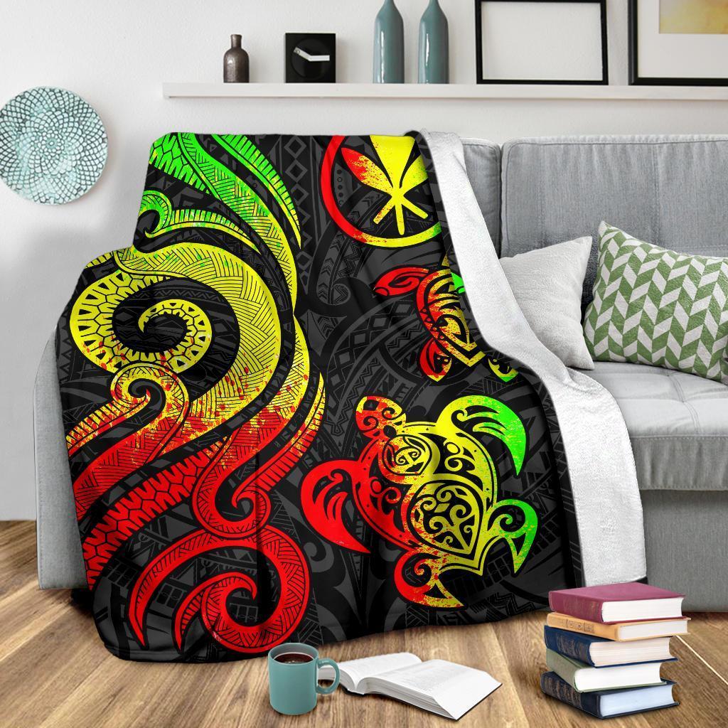 Reggae turtle blanket spread on gray couch, black base with bright green red yellow artwork