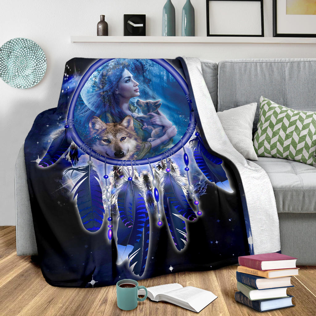 Blue wolf dreamcatcher blanket draped over couch with large central oval print