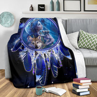 Blue wolf dreamcatcher blanket draped over couch with large central oval print