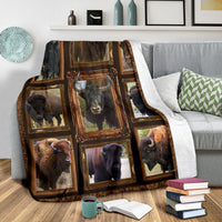 Multicolor buffalo/bison photo blanket with white reverse, draped over sofa