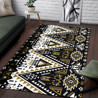Tribal area rug with bold arrows, triangles, and starburst medallions in black, white, gold