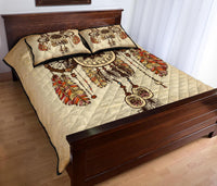 Dreamcatcher quilt bed set on dark wood bed frame, tan cover with multicolor feather print