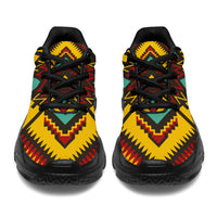 Front view chunky sneakers in yellow with red and teal geometric ornament, black laces