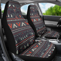 Two car seat covers installed: tribal elephant print with red, cream, and teal lines