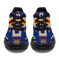 Blue native-print sneakers shown from heel view with black laces and thick sole.