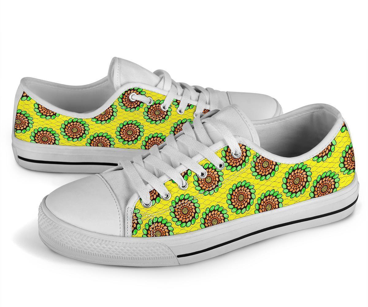 Angled low-top sneakers, green/yellow Ankara spiral print on white upper, white sole