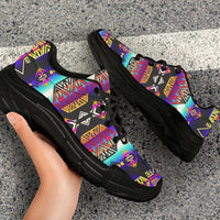 Chunky sneakers with colorful Native American motifs, black laces, worn on pavement