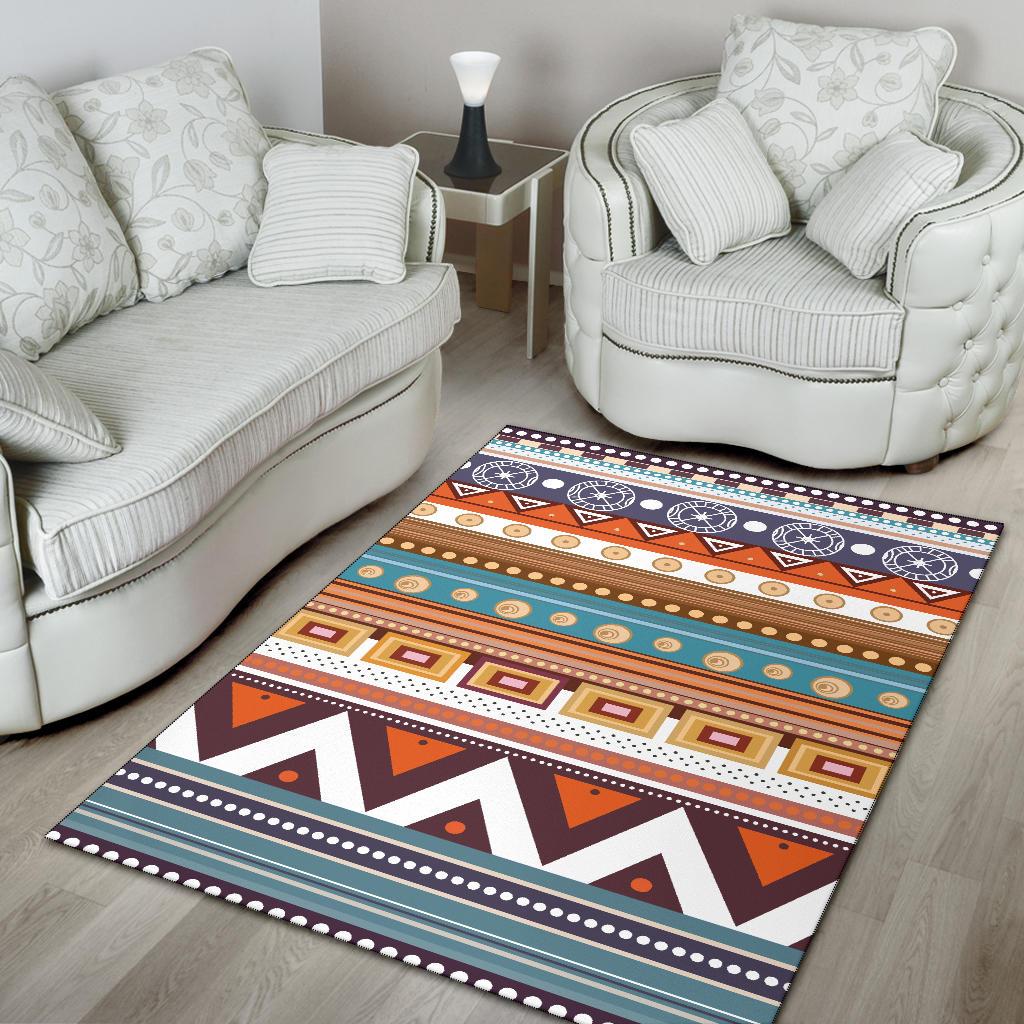 Multicolor geometric area rug with bold triangles, squares, and dotted trim stripes.