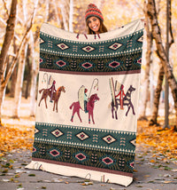 Chief horse blanket held outdoors, teal geometric band and horse rider panel