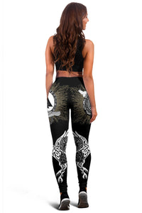 Back view of black women’s leggings with circular rune symbols and winged motifs