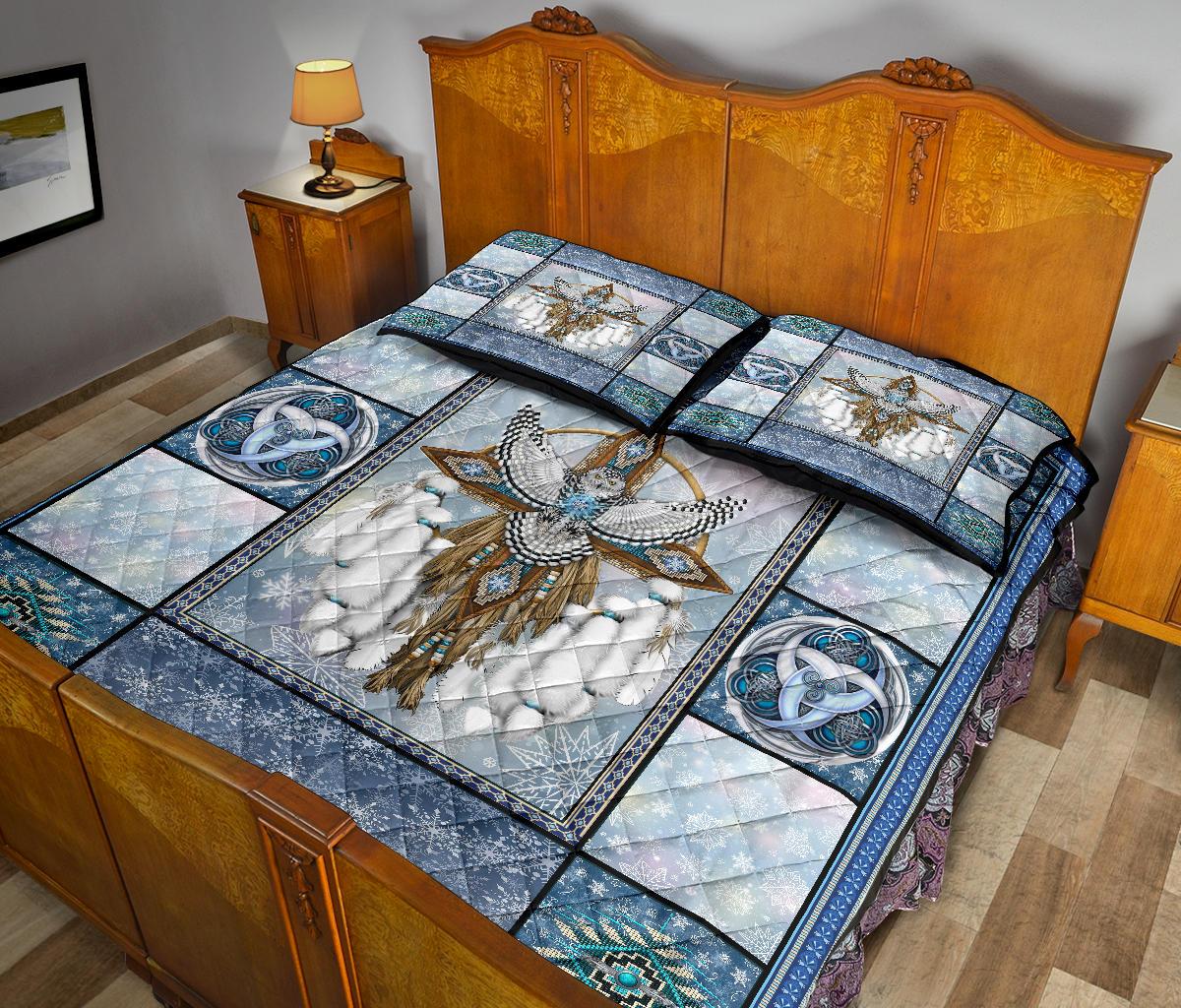 Quilt bed set with owl dreamcatcher centerpiece, blue pattern blocks, and matching shams