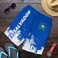 Folded blue El Salvador swim shorts with white smudge print and side crest logo