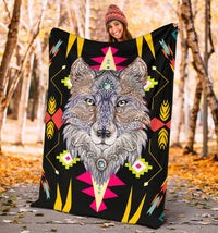 Stylized wolf face blanket held outdoors, black with pink, yellow, and teal geometric accents