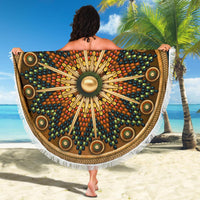 Round beach blanket towel with radial native-style design on dark brown and long white fringe