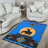 Blue area rug with black horse silhouette, yellow sun disk, and red, teal, and white geometric designs