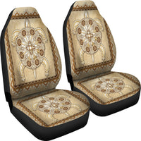 Tan car seat cover set with two front panels, beaded flower cross motifs and patterned edges