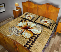 Beige quilt bed set with hibiscus and sea turtle artwork, black zigzag trim