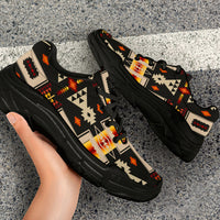 Side view black chunky sneakers with multicolor geometric tribal-style print and lace-up