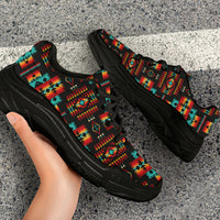 Pair of chunky sneakers with multicolor Native-style pattern and black outsole