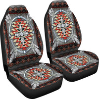 Two car seat covers with gray oval medallion, red zigzag cross, and tribal border pattern