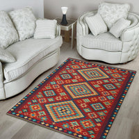Geometric patterned area rug with red, teal, and yellow blocks along a dark border