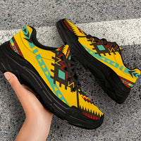 Close-up of yellow chunky sneakers with geometric zigzag pattern and black outsole
