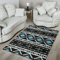 Black geometric area rug with white zigzag bands and teal diamond accents