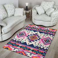 White base Native American style rug with navy triangles and bright pink, teal, and yellow.