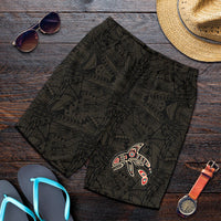Black men’s shorts with dark tribal pattern and colorful killer whale graphic on leg
