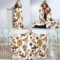 White hooded blanket laid flat, colorful Native-style symbols with horses and dreamcatchers