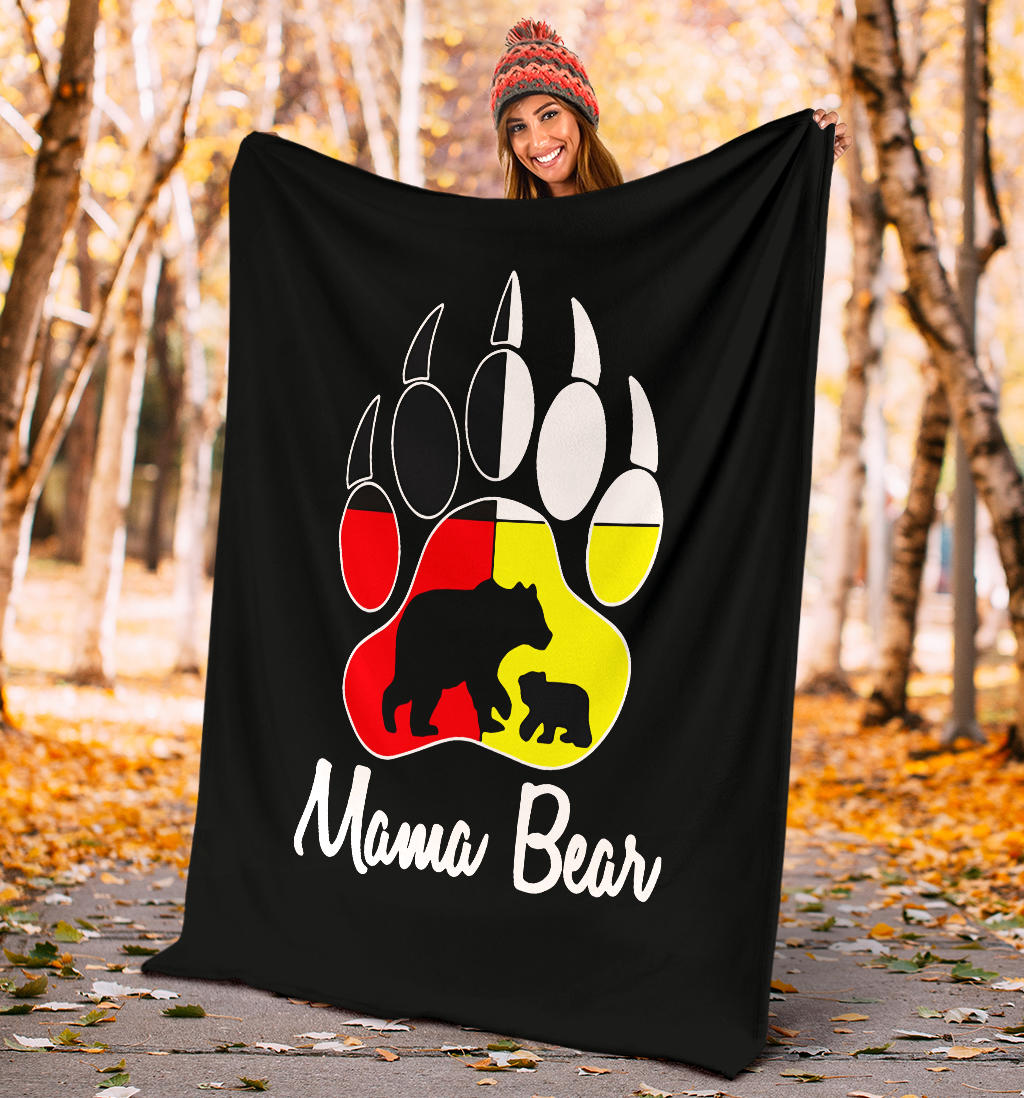 Black blanket held up outdoors with colorful bear paw print and 'Mama Bear'
