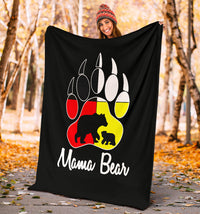 Black blanket held up outdoors with colorful bear paw print and 'Mama Bear'