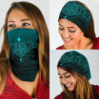 Dark teal neck gaiter with teal rune mandala print, worn across face and forehead