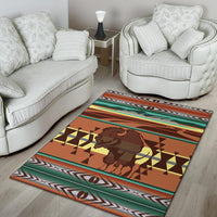 Multicolor bison area rug with warm orange field, geometric triangles, and zigzag trim.