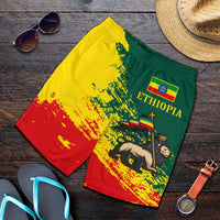 Flat-lay Ethiopia graphic shorts, green yellow red splatter print, elastic waistband