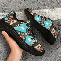 Chunky sneakers with turquoise geometric pattern and black sole, laced front view