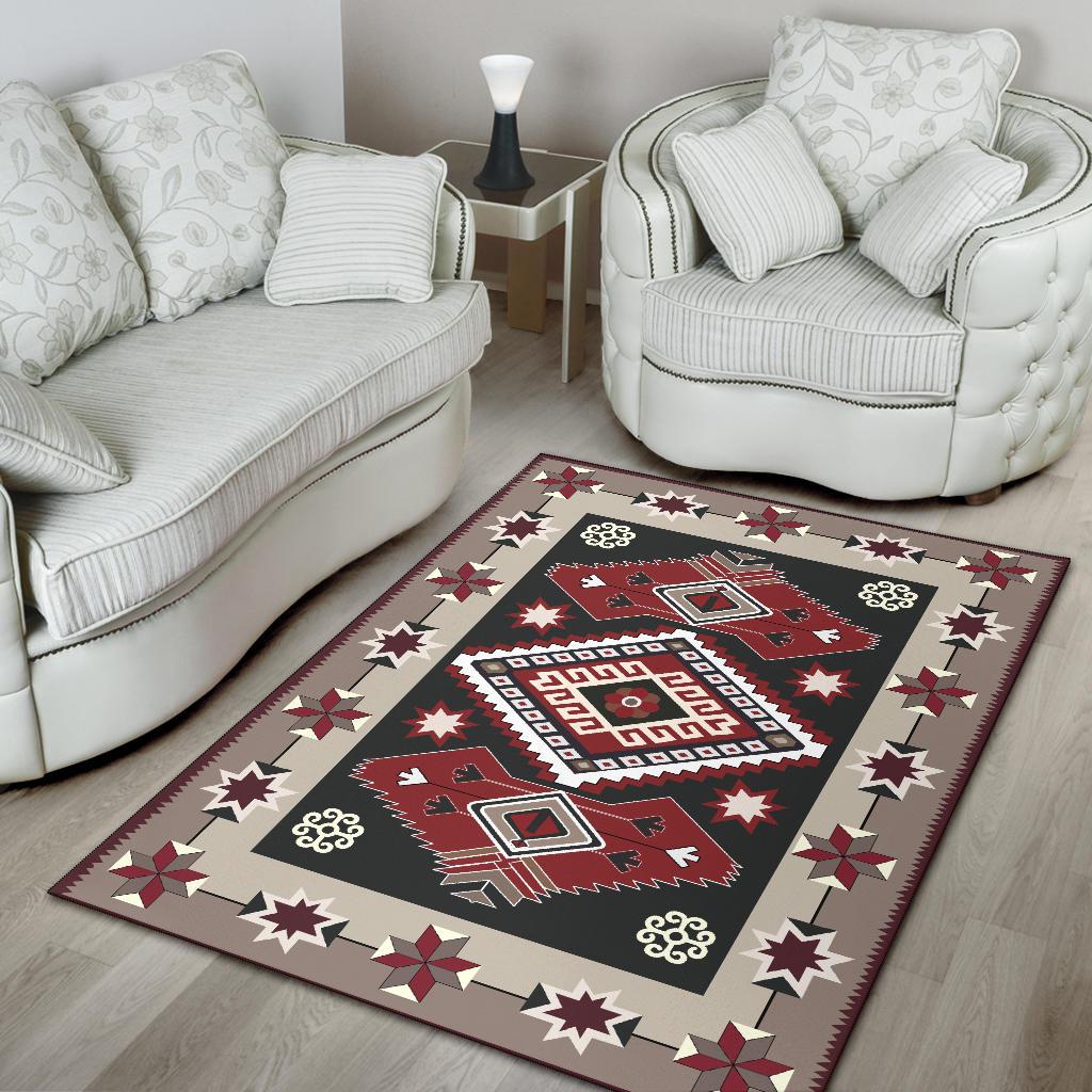 Tribal pattern area rug with black field, red brown shapes, cream border stars and flowers