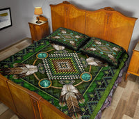 Green quilt bed set on wooden bed frame; feather and turquoise ring medallion