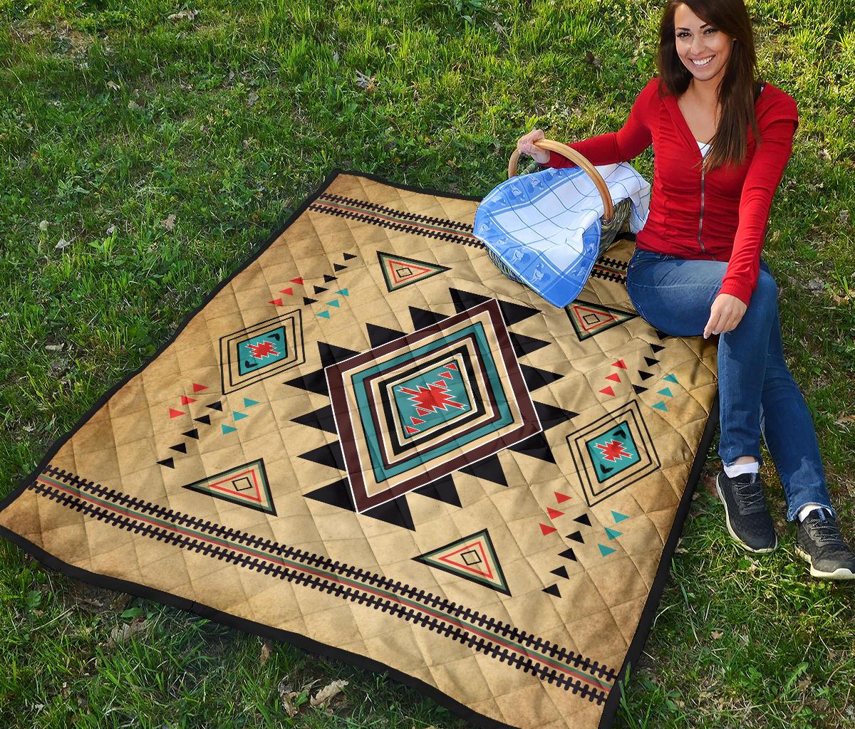 Colorful southwest geometric quilt laid flat, featuring a large central diamond and tan background.