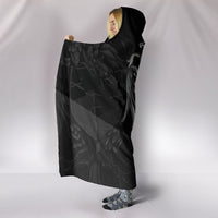 Black hooded blanket back view with wing pattern and over-the-shoulder drape