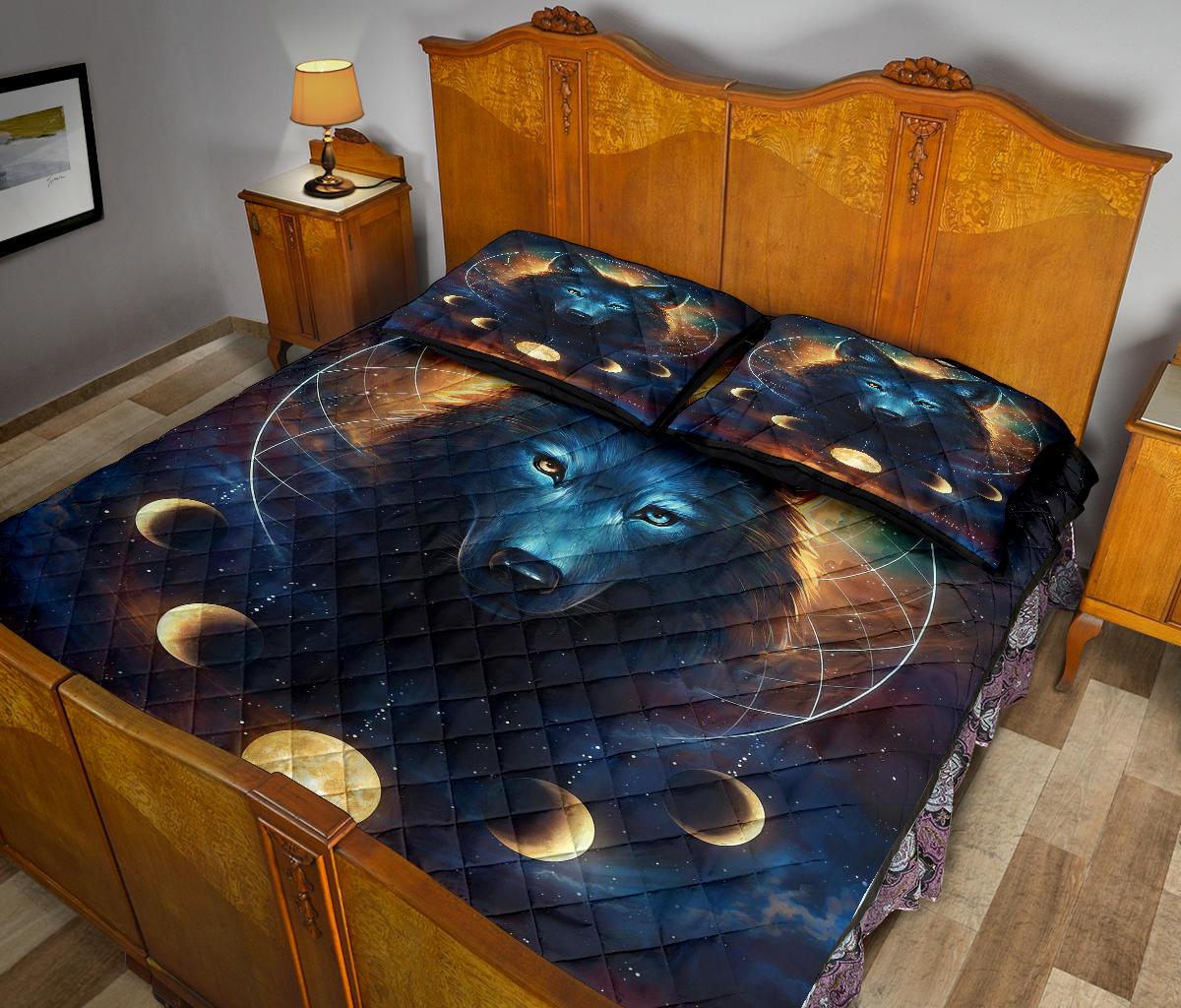 Wolf quilt bed set featuring dark blue fabric, moon phases, and glowing gold highlights