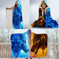 Hooded wolf blanket set outdoors, blue wolf face on one side and fiery orange on the other