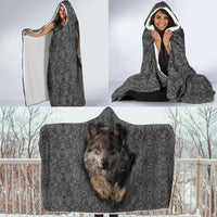 Gray hooded blanket with wolf face and swirl pattern, laid flat